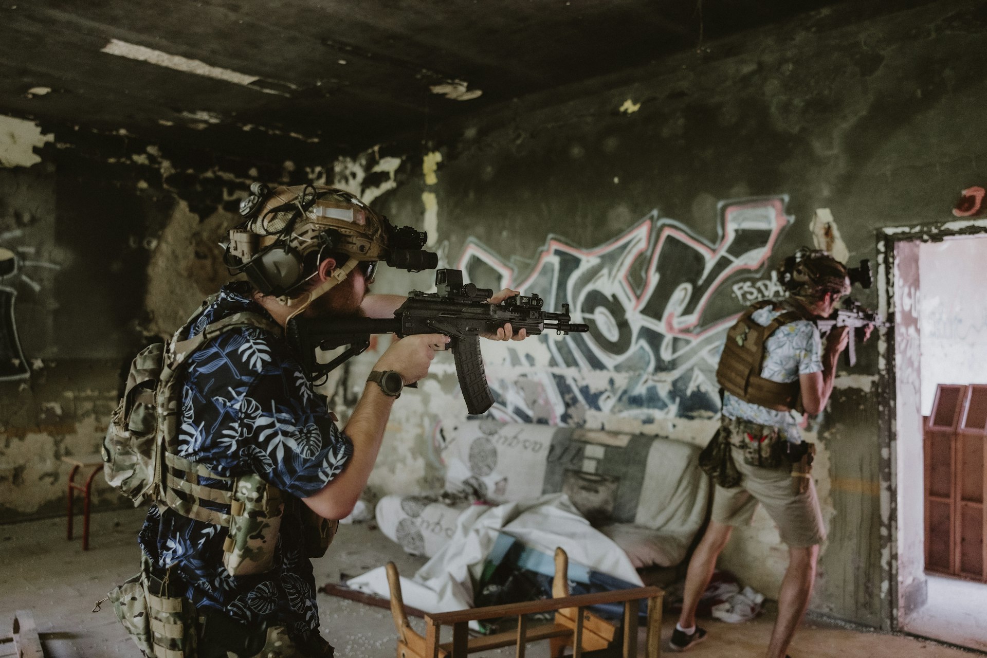 A group of men standing in a room with graffiti on the walls