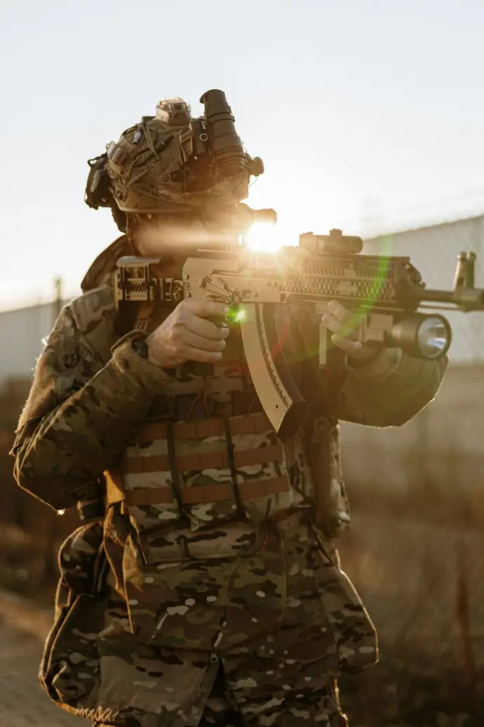 A man in camouflage holding a machine gun